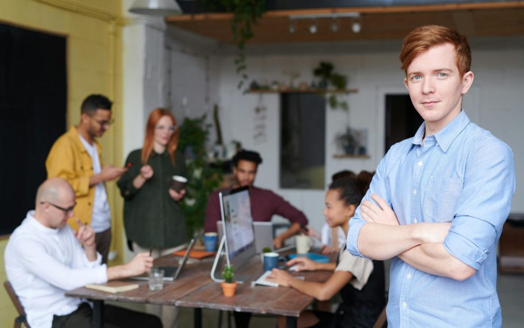 young leader standing in front of a business team